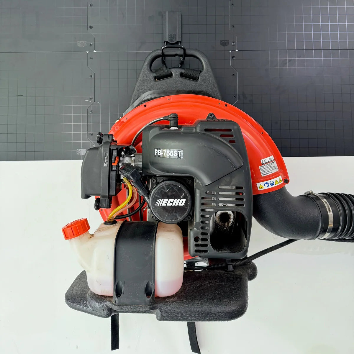 Gator Magnetics The Complete Workshop 10 Bundle — petrol leaf blower stored on a hook on a black steel panel