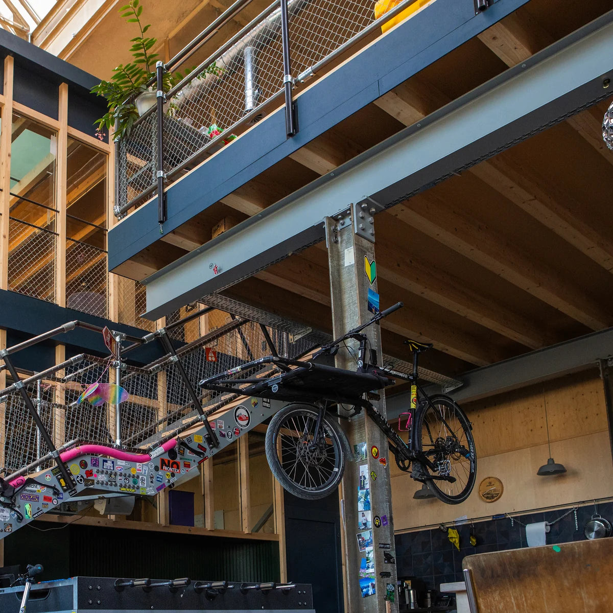 Gator Magnetics The Complete Workshop 10 Bundle — bicycle suspended from black hooks on a galvanised steel column